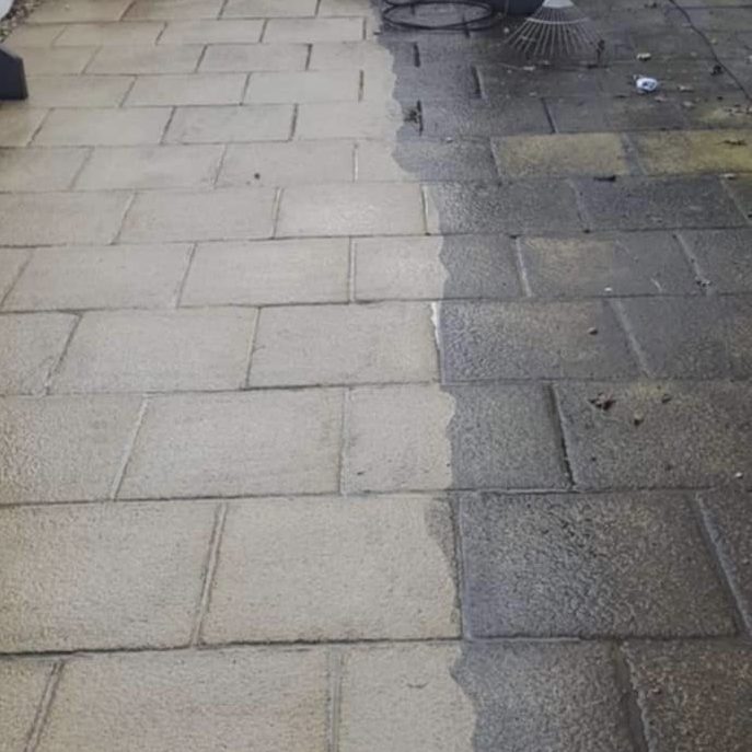 Cottage Grounds Maintenance exterior cleaning showing a clear contrast between the two sides of pavement.